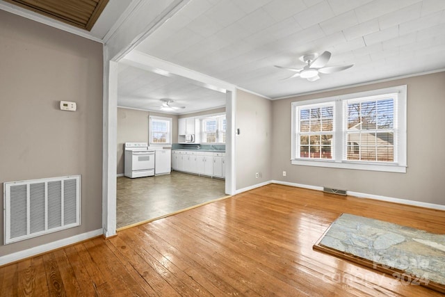 unfurnished living room with wood-type flooring, ceiling fan, and crown molding