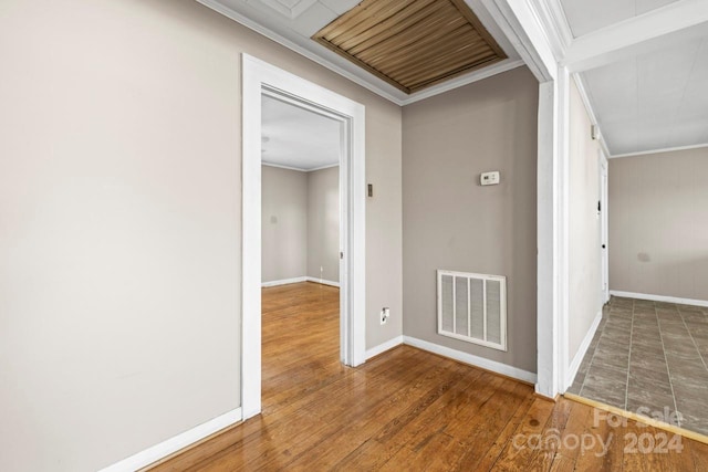 hallway featuring crown molding and hardwood / wood-style flooring