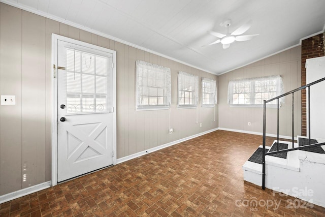 interior space featuring crown molding, plenty of natural light, lofted ceiling, and ceiling fan