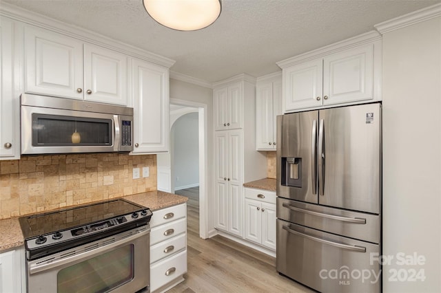 kitchen featuring light hardwood / wood-style floors, white cabinetry, and stainless steel appliances