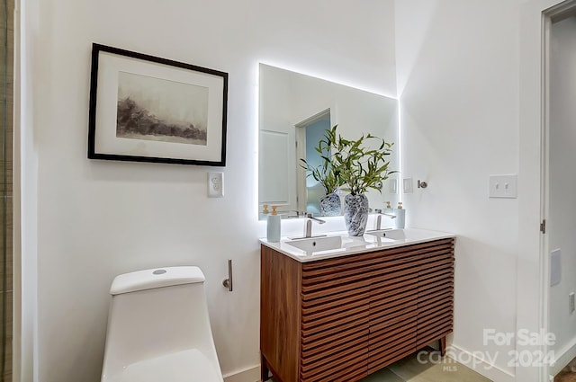 bathroom featuring vanity and toilet