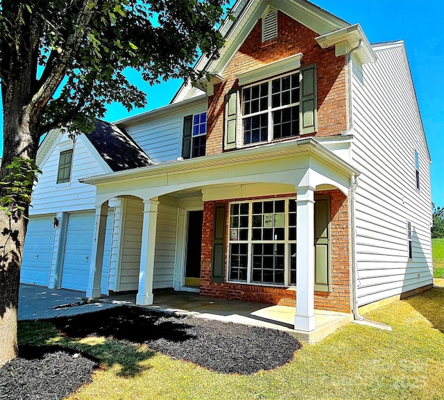 view of front of home with covered porch and a garage