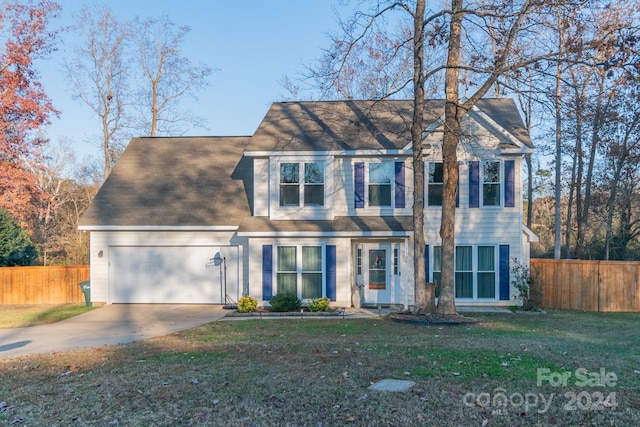 view of front of house featuring a front yard and a garage