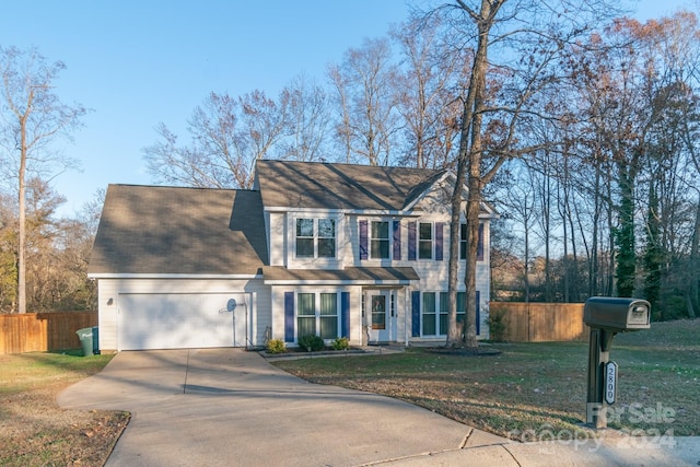 colonial-style house with a garage and a front lawn