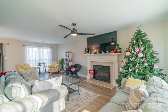 living room with ceiling fan and light hardwood / wood-style flooring