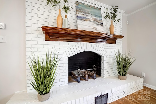 details with hardwood / wood-style flooring, crown molding, and a brick fireplace