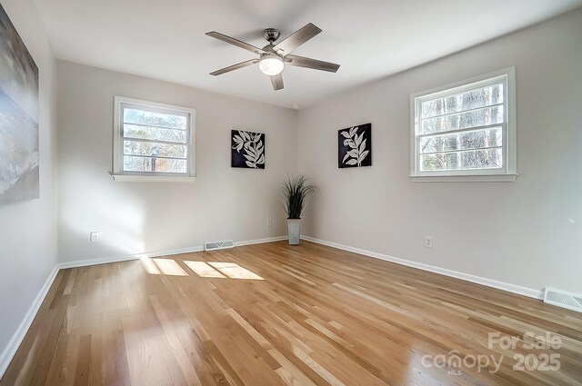 empty room featuring ceiling fan and light hardwood / wood-style floors