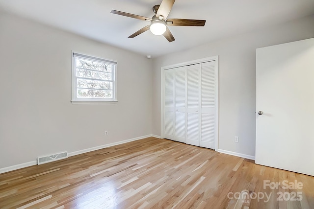 unfurnished bedroom featuring ceiling fan, a closet, and light hardwood / wood-style floors