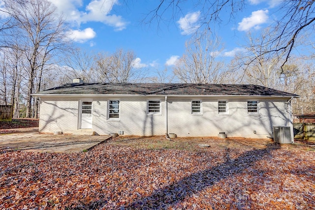 rear view of property featuring central AC and a patio area