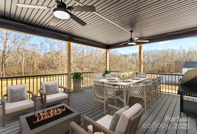 deck featuring an outdoor fire pit and ceiling fan