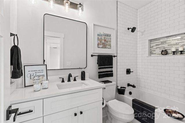 full bathroom with toilet, vanity, and tiled shower / bath combo