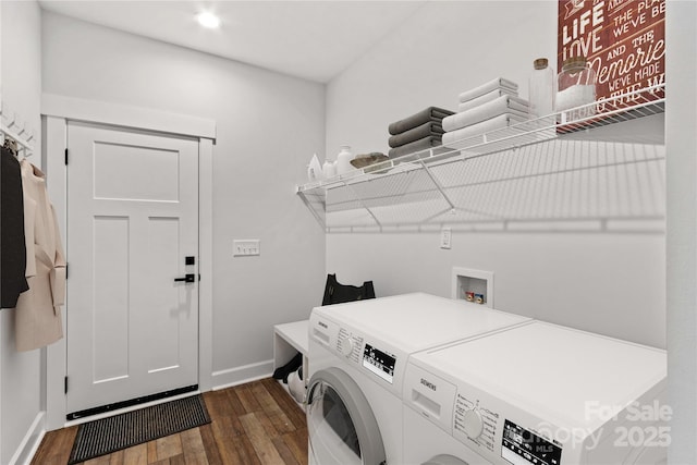 clothes washing area with dark hardwood / wood-style floors and washer and clothes dryer