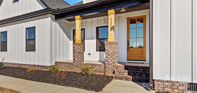 view of exterior entry featuring a porch