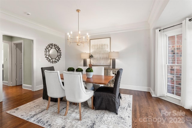 dining area with ornamental molding, a notable chandelier, dark wood finished floors, and baseboards