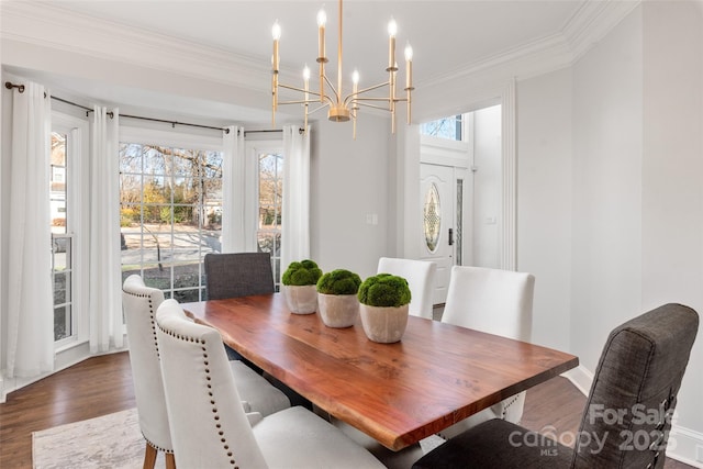 dining area featuring a healthy amount of sunlight, baseboards, dark wood finished floors, and crown molding