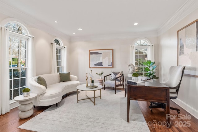 home office with crown molding, baseboards, a wealth of natural light, and wood finished floors