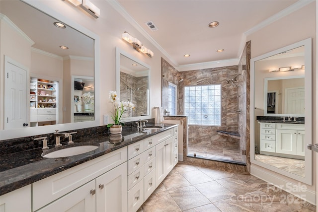 bathroom with a sink, walk in shower, visible vents, and crown molding