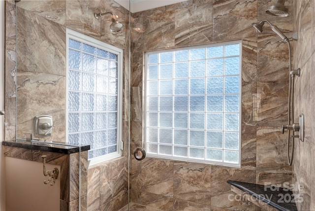 full bath with tiled shower