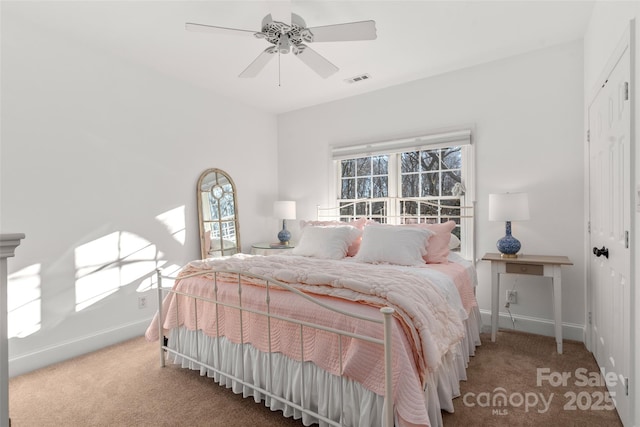 carpeted bedroom with a closet, visible vents, ceiling fan, and baseboards