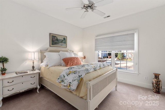 carpeted bedroom with baseboards, visible vents, and a ceiling fan