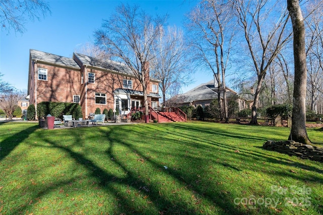 view of yard with a patio area and stairway