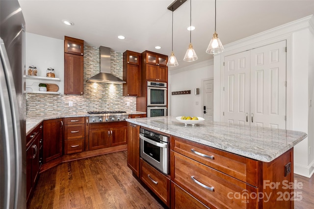 kitchen with wall chimney range hood, a kitchen island, glass insert cabinets, and open shelves