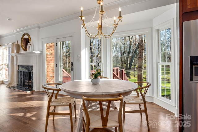 sunroom / solarium with a high end fireplace and a notable chandelier