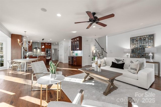 living room with ornamental molding, wood finished floors, and recessed lighting