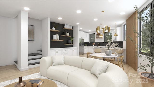 living room with sink and light hardwood / wood-style floors