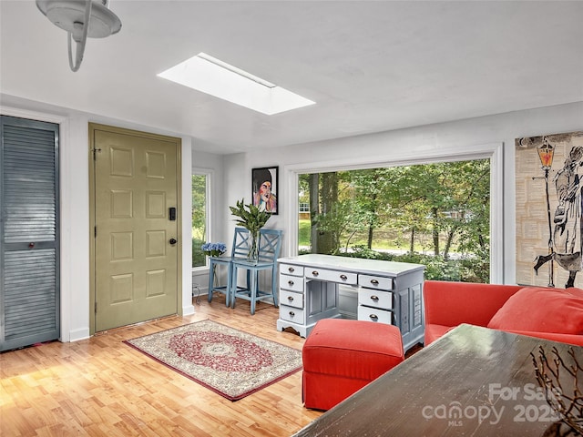 entrance foyer with a skylight and light hardwood / wood-style floors