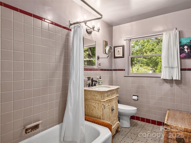 full bathroom featuring tile walls, vanity, toilet, shower / bath combo, and tile patterned floors