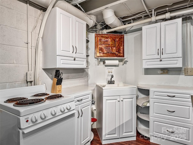 kitchen featuring white range with electric cooktop, sink, and white cabinets