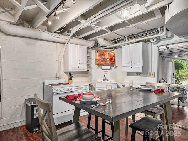 interior space with dark hardwood / wood-style floors, white electric stove, sink, and white cabinets