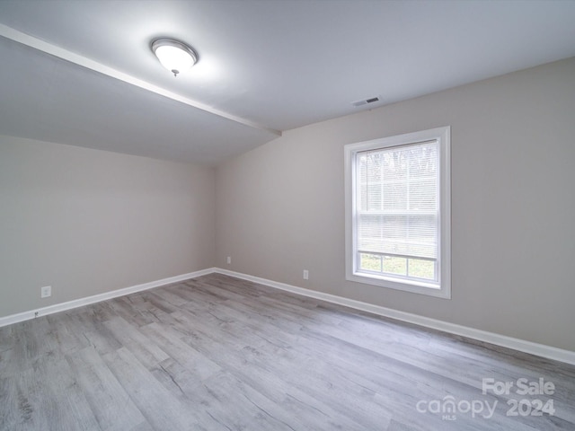 interior space featuring light hardwood / wood-style flooring and vaulted ceiling