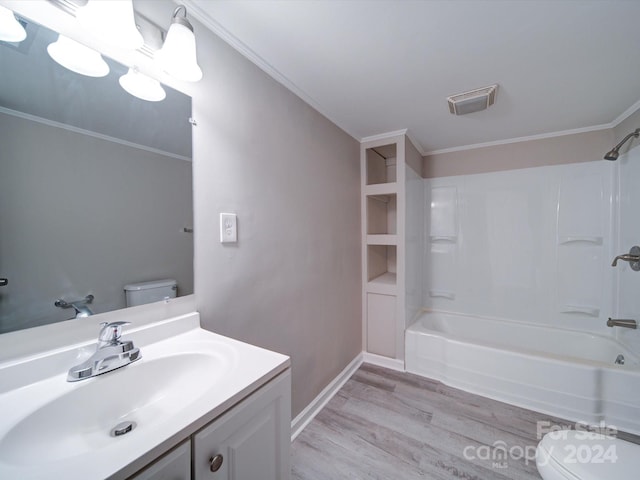 full bathroom featuring wood-type flooring, toilet, shower / tub combination, vanity, and ornamental molding