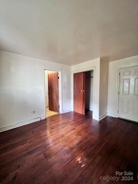 empty room with dark hardwood / wood-style floors