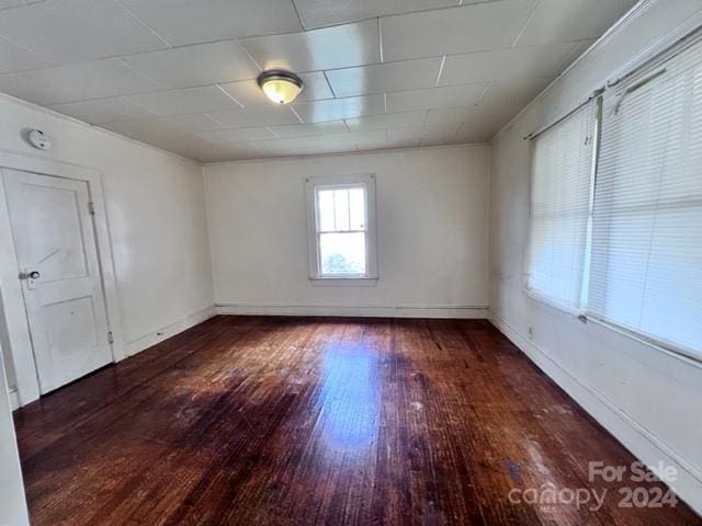 empty room with dark hardwood / wood-style floors