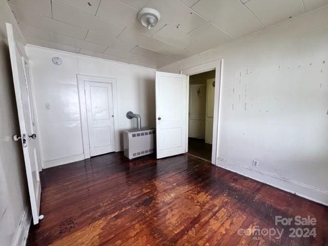 unfurnished bedroom with dark hardwood / wood-style floors