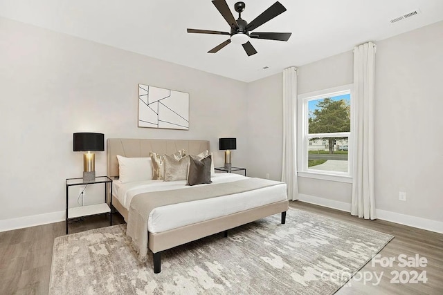 bedroom with ceiling fan and wood-type flooring