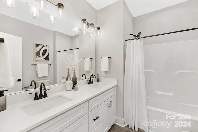 full bathroom featuring vanity, hardwood / wood-style flooring, toilet, and shower / bath combo with shower curtain