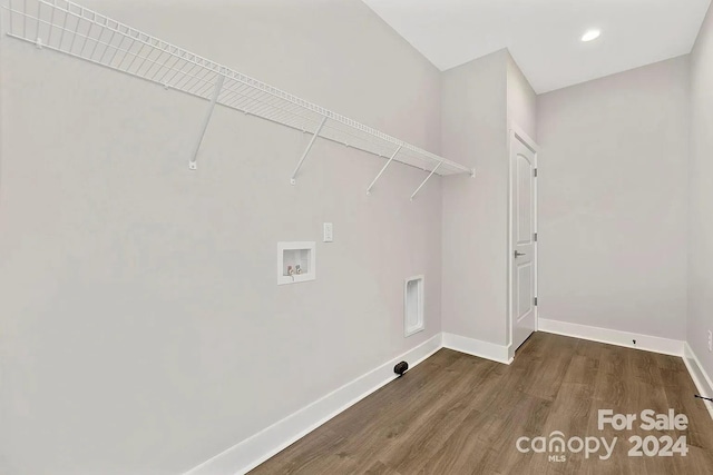 clothes washing area with hookup for a washing machine and dark hardwood / wood-style flooring