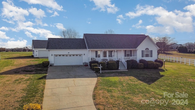 ranch-style home with a garage, a porch, and a front yard