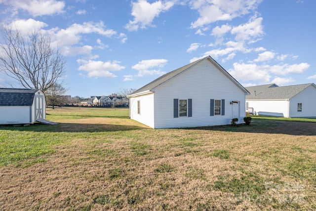 view of property exterior with a storage unit and a yard