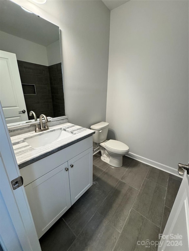 bathroom featuring hardwood / wood-style floors, vanity, and toilet