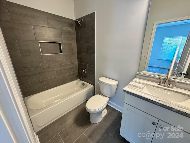 full bathroom featuring vanity, tiled shower / bath combo, and toilet