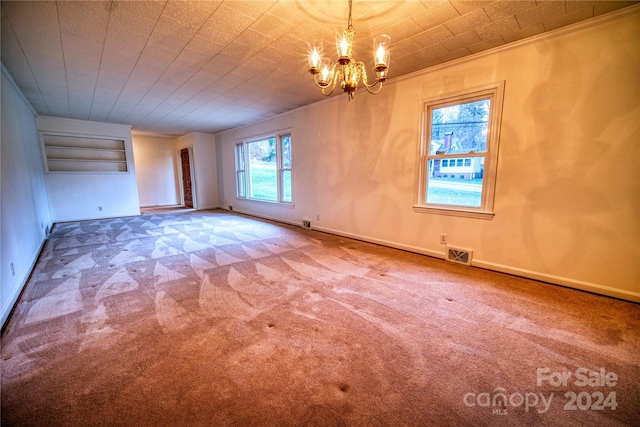 unfurnished room with carpet flooring, plenty of natural light, and a notable chandelier