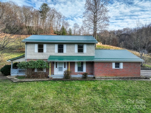 view of front of house with covered porch and a front lawn