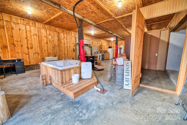 misc room with concrete floors and wooden walls