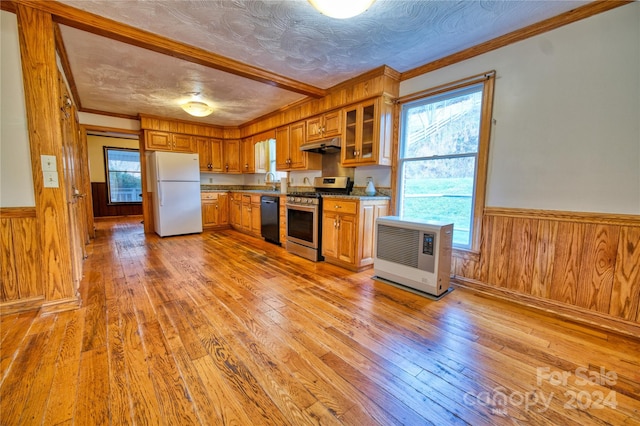 kitchen featuring dishwasher, gas range, white fridge, and light hardwood / wood-style flooring