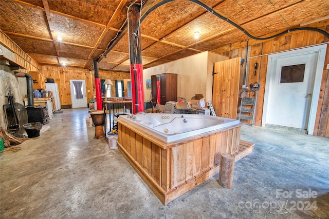 playroom with a wood stove and wood walls